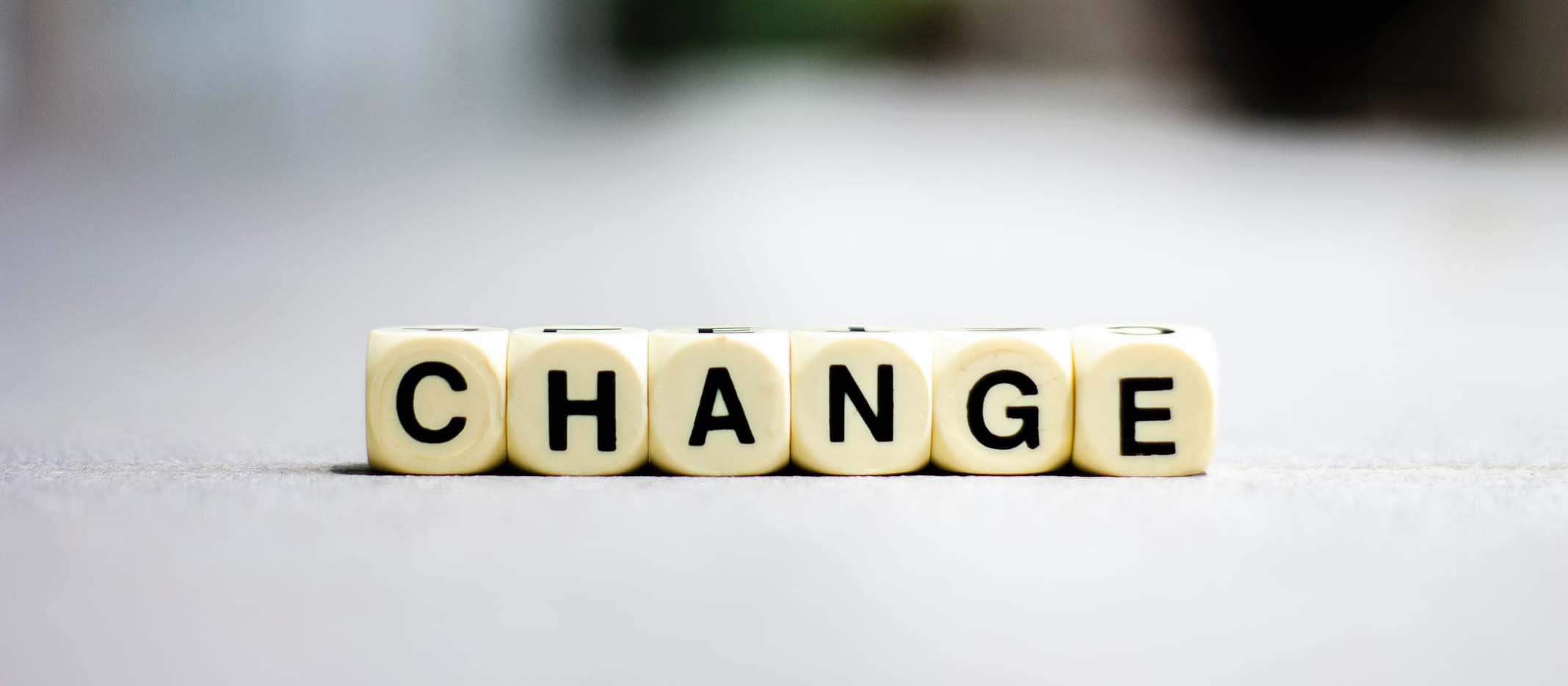 The word 'change' spelt out with dice with letters on.